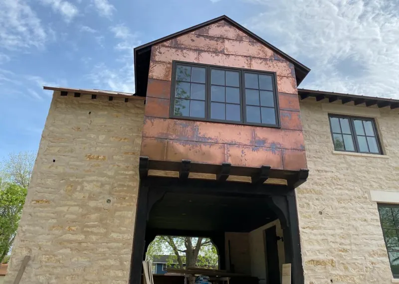 Copper metal panel facade on a stone building for Roof Repair in Lake Norman of Catawba